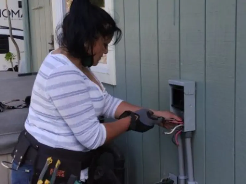 Licensed electrician wiring an exterior subpanel in Fayette